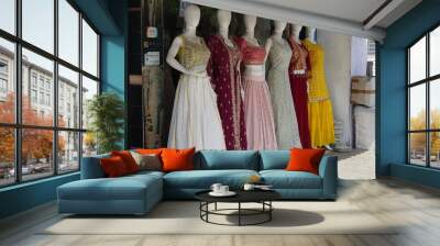 Mannequins dressed in latest fashion in front of retail clothes shop. Fashion and Retail Shopping concept. Mannequin Of Female Girls Wearing Colorful Indian dresses. - Mumbai India: May 2021 JYH Wall mural