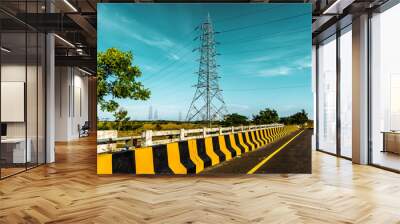 Silhouette effect of high voltage electric towers with electricity transmission power lines, located near riverside and sunset sky background	 Wall mural