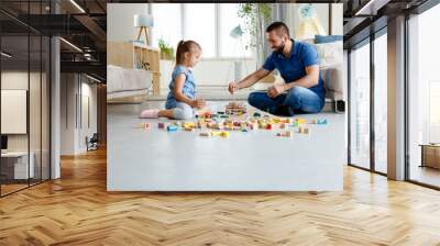 Father with daughter playing together at home Wall mural