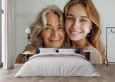 Portrait of old mother and mature daughter. Happy senior mom and adult daughter embracing with love on a white background, Generative AI Wall mural