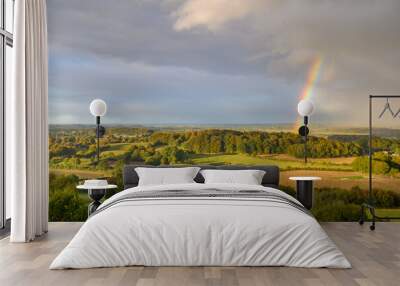 Hilly and hedging  landscape with rainbow. Hedging  landscape of north Germany by Hüttener Berge. View from Aschberg, Schleswig-Holstein, Germany. Wall mural