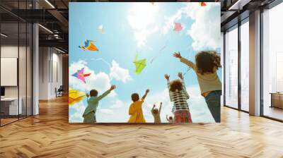 A diverse group of children enjoying a sunny and windy day flying kites outdoors, playing under the sun,welcoming spring Wall mural