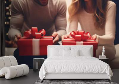 First-person view of a child receiving gifts from their young parents on Christmas Day in the living room at home Wall mural