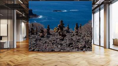 Stack of pebbles on the coast of Adeje Tenerife Spain Wall mural