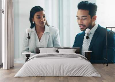 Tablet, meeting and partnership with business people working in an office as a team for research. Technology, planning or teamwork with a man and woman employee reading information in the workplace Wall mural