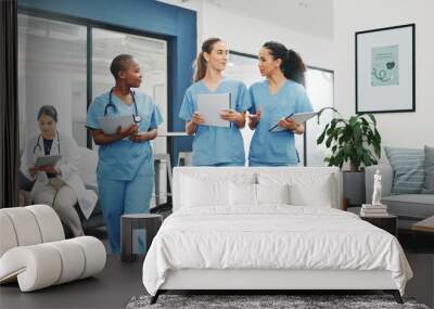 Talking nurses, walking and documents in hospital teamwork, diversity collaboration or bonding on surgery or clinic break. Smile, happy and healthcare women with medical research, paper or funny joke Wall mural