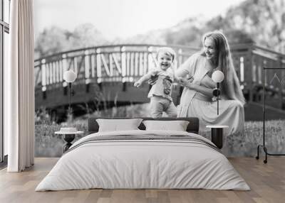 Young mother with daughter in park , black and -white photo Wall mural