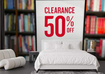 50 percent sale sign board in front of bookshelf in the book store. Wall mural