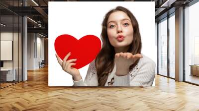 Beautiful teenage girl showing red heart from cardboard to camera and blows a kiss, valentine's day Wall mural