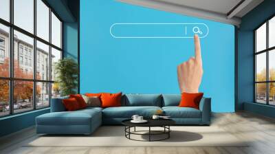 Finger presses the search button in the search bar on a blue background. Wall mural