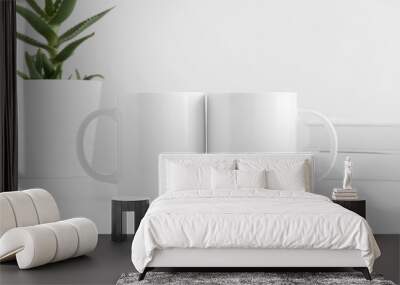 Two white mugs mockup with a aloe vera in a pot and books on a white table. Wall mural