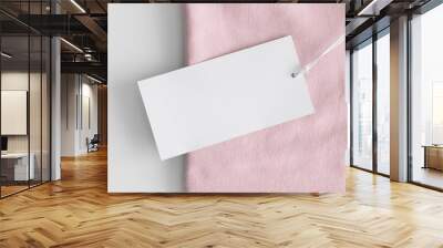 White clothing tag mockup on a soft pink t-shirt. Wall mural