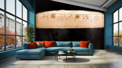 Glass of dark beer isolated on black background. Foam close up. Wall mural