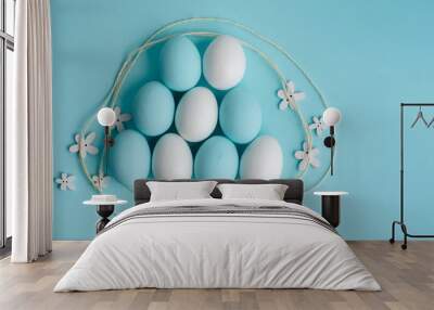 Spring and Easter holiday concept. Easter eggs painted blue and white, pastel color background. Isolated on white. Wall mural