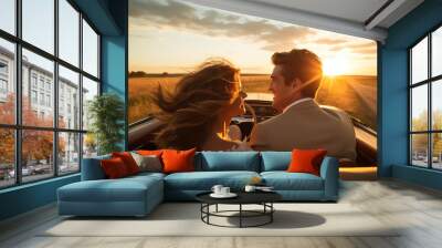 A couple in love riding in an open-top car at sunset. Man and woman, back view, traveling in a vintage car. Creative concept of a romantic tour for two. Wall mural