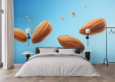 Closeup of almond nuts falling surrounded by almond crumbs isolated on flat blue background with copy space. 3d render illustration style.  Wall mural