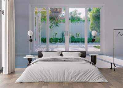 Modern sliding doors with panoramic glass windows opening in the interior of a modern country private house. Wall mural