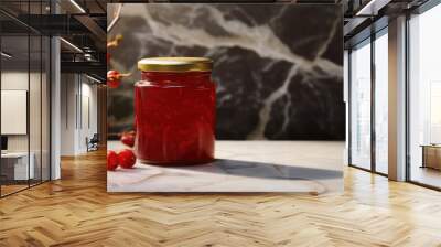 Pureed red cranberry sauce in a glass jar on the table. Traditional Thanksgiving jam, natural berry sauce. Wall mural