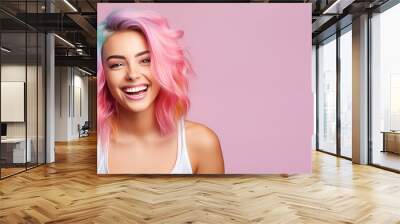 Young beautiful smiling happy woman with rainbow colored wavy hair isolated on flat pink background with copy space, banner template of Creative hair coloring. Wall mural