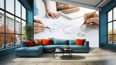 Architects engineer discussing at the table with blueprint - Closeup on hands and project print, Team group on construciton site check documents and business workflow Wall mural