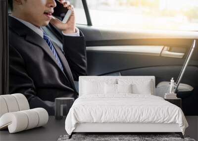 Attractive handsome young businessman using mobile smart phone in car Wall mural