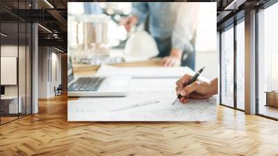 Close-up Of Person's engineer Hand Drawing Plan On Blue Print with architect equipment, Architects discussing at the table, team work and work flow construction concept Wall mural