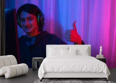 Game stream concept, Male streamer wear headset and have fun to play games online for live stream Wall mural