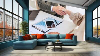 Good deal career and placement concept, successful young businessmen shaking hands after successful negotiation in modern office. Wall mural