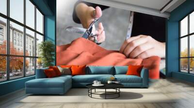 Hands notch tailor tailor's scissors cloth cutting a piece of fabric (fashion designer concept). Wall mural