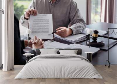 Male lawyer showing contract and pointing the signature box for signing while explaining and consultation about legislation agreement and terms data of business contract to businessman in law firm Wall mural