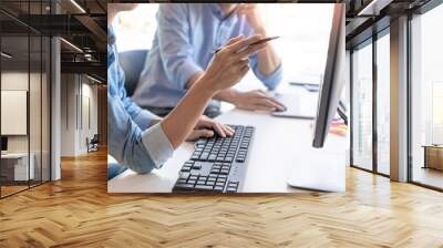 Pensive programmer working on on desktop pc programming code technologies or website design at office Software Development Company Wall mural