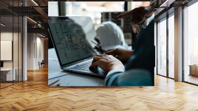 Two engineer working to discuss and brainstorming about construction blueprint on laptop in office Wall mural