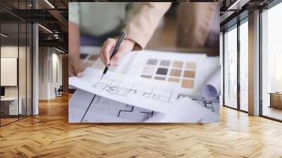 Two female architects discuss and brainstorm about interior designing building project on blueprint Wall mural