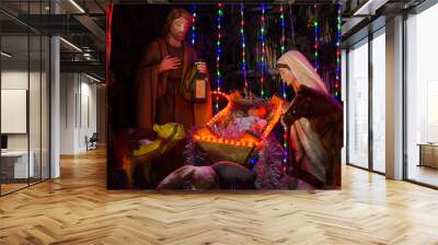  Josepf, Jesus and  Maria, in the stable during the Christmas season.Surrounded by Christmas decorations Wall mural