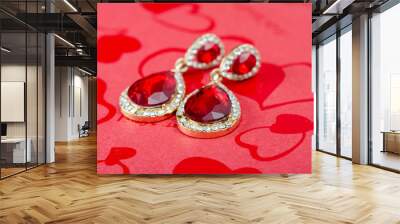 Close-up  pair of red gemstone earrings ready for valentine's day or engagement gift on    red   background . Wall mural