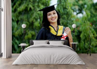 Young female student with diploma at outdoors Wall mural