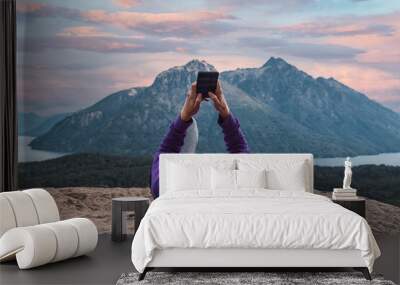 woman checking mobile, relaxed in mountainous forest Wall mural