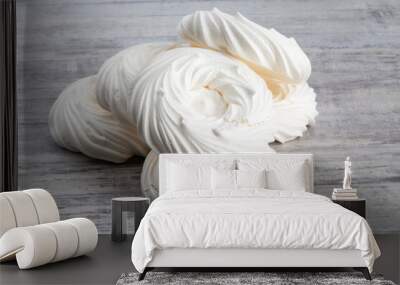 a pile of white meringue nests on a grey table top Wall mural