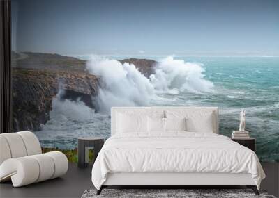 A huge ocean waves breaking on the coastal cliffs in at the cloudy stormy day. Breathtaking romantic seascape of ocean coastline. Peniche, Portugal. Wall mural