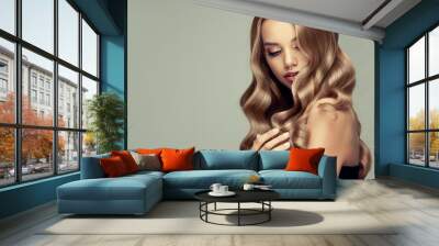  blonde girl with long  and   shiny wavy hair .  Beautiful  smiling woman model with curly hairstyle .
 Wall mural