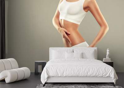  Perfect slim toned young body of the girl . An example of sports , fitness or plastic surgery and aesthetic cosmetology. Wall mural