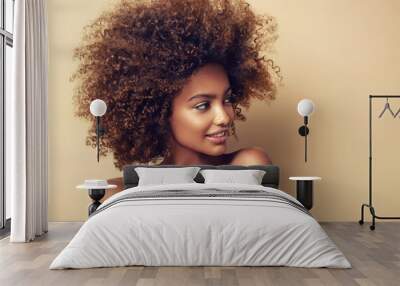 Beautiful black woman . Beauty portrait of african american woman with clean healthy skin on beige background.  Smiling beautiful afro girl.Curly black hair Wall mural