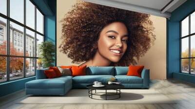 Beautiful black woman . Beauty portrait of african american woman with clean healthy skin on beige background.  Smiling beautiful afro girl.Curly black hair Wall mural