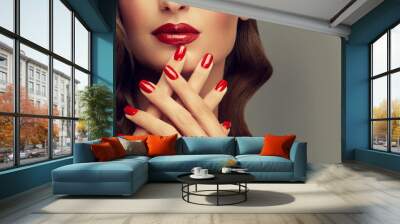 Beautiful girl with long wavy hair . woman with red manicure . girl with bright color nail polish on the nails . Makeup and cosmetics
 Wall mural