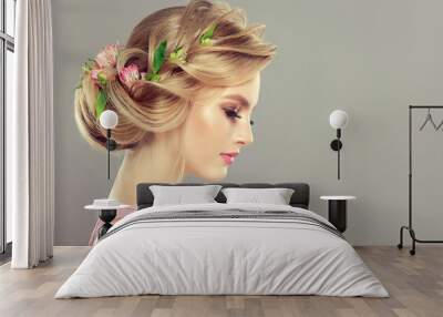 Beautiful model girl  with elegant hairstyle and rose flowers in a plait . Woman with fashion  spring hair. Wall mural