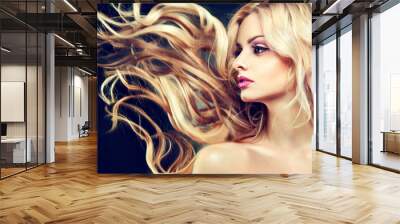 Beautiful model with flying long blonde hair . Wall mural