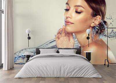 Beautiful spa woman with water splashes. Moisturizing facial skin, beauty and care. Wall mural