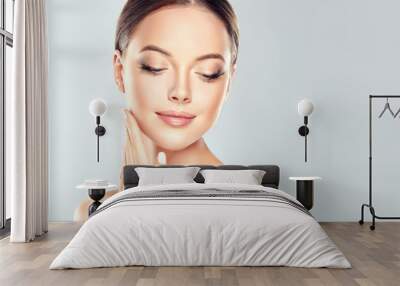 Beautiful Young Woman with Clean Fresh Skin  touch own face . Facial  treatment   . Cosmetology , beauty  and spa .
 Wall mural