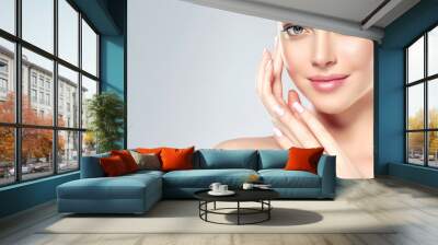 Beautiful Young Woman with Clean Fresh Skin  touch own face . Facial  treatment   . Cosmetology , beauty  and spa . Wall mural