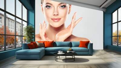 Beautiful Young Woman with Clean Fresh Skin  touch own face . Facial  treatment   . Cosmetology , beauty  and spa .
 Wall mural